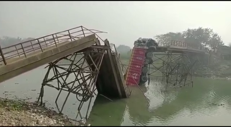 the truck was passing with sand,then the bridge broke and diveided into two parts.