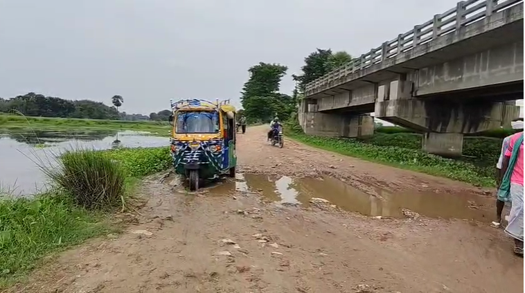 The bridge was built, but the approach path was not. The bridge standing in the field became a matter of concern, raising questions about its utility.